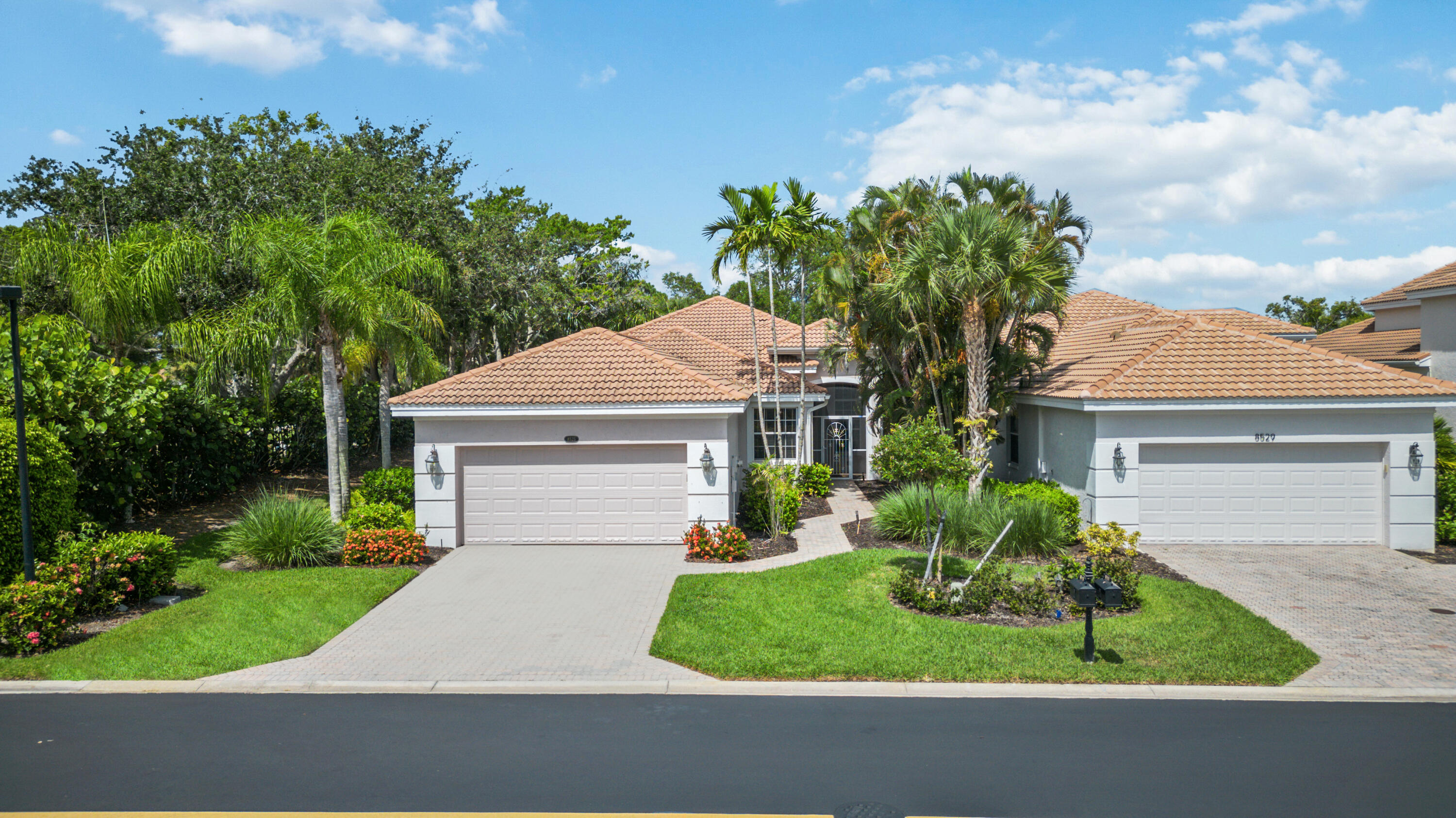 8525 Peppertree Way Naples, FL 34114 - Photo 3 of 47 a front view of a house with a yard and garage