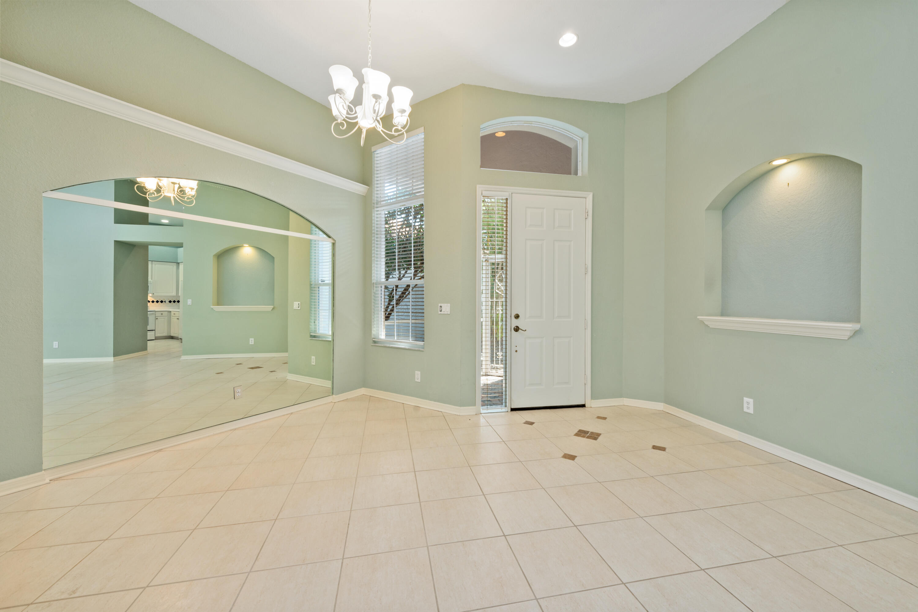 8525 Peppertree Way Naples, FL 34114 - Photo 10 of 47 a view of a hallway with chandelier and front door