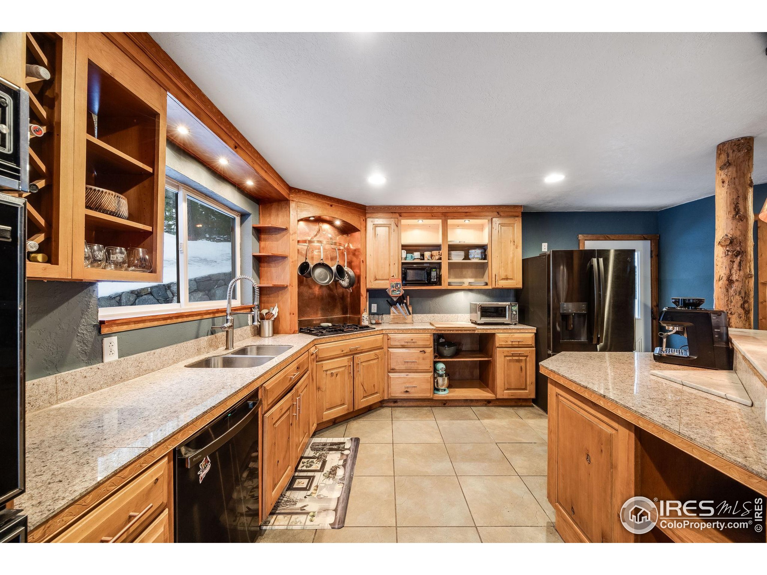 46 Apache Road Evergreen, CO 80439 - Photo 13 of 39 a large kitchen with stainless steel appliances lots of counter top space