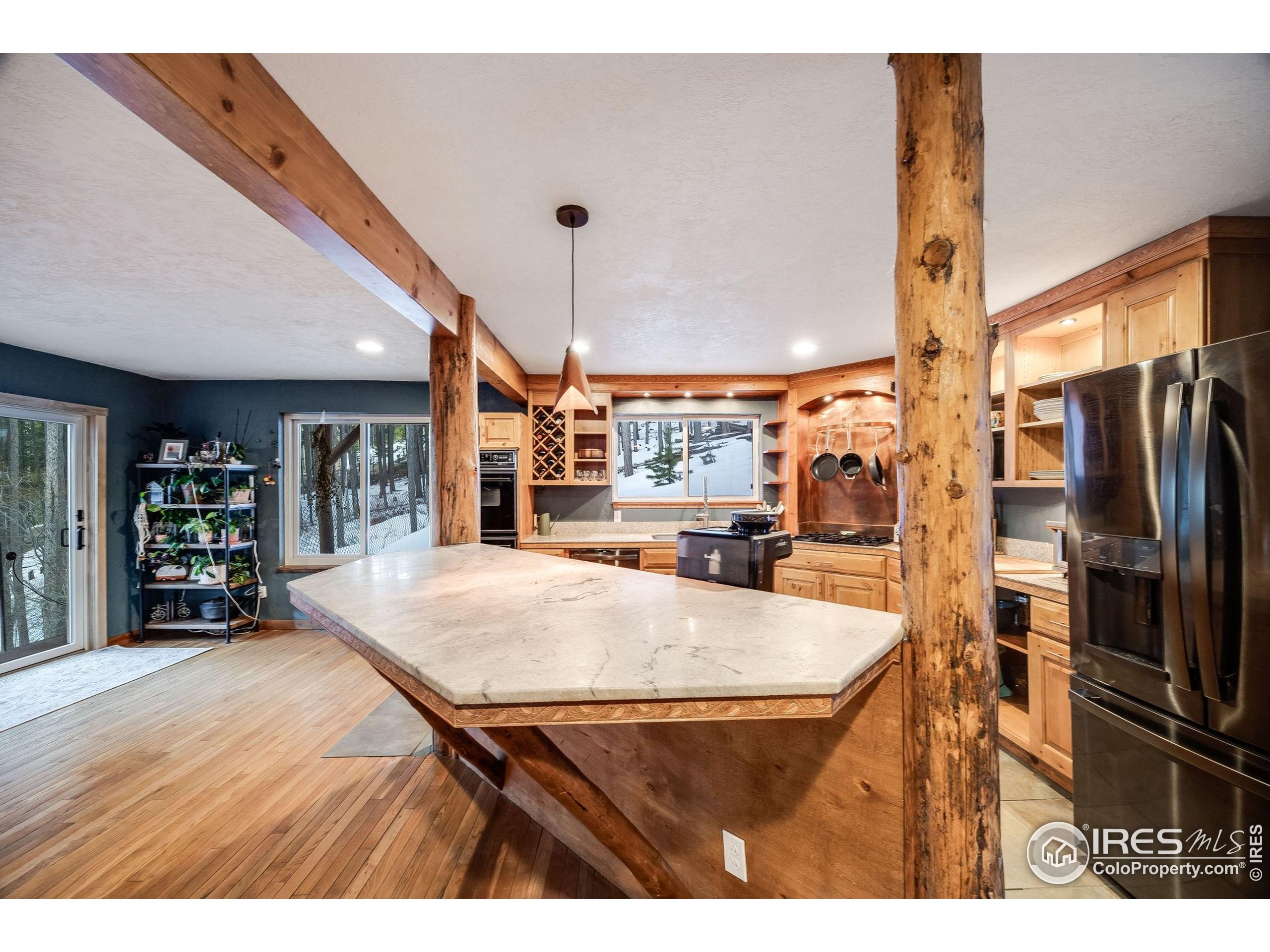 46 Apache Road Evergreen, CO 80439 - Photo 17 of 39 a kitchen with stainless steel appliances kitchen island granite countertop a refrigerator a stove and a sink with cabinets