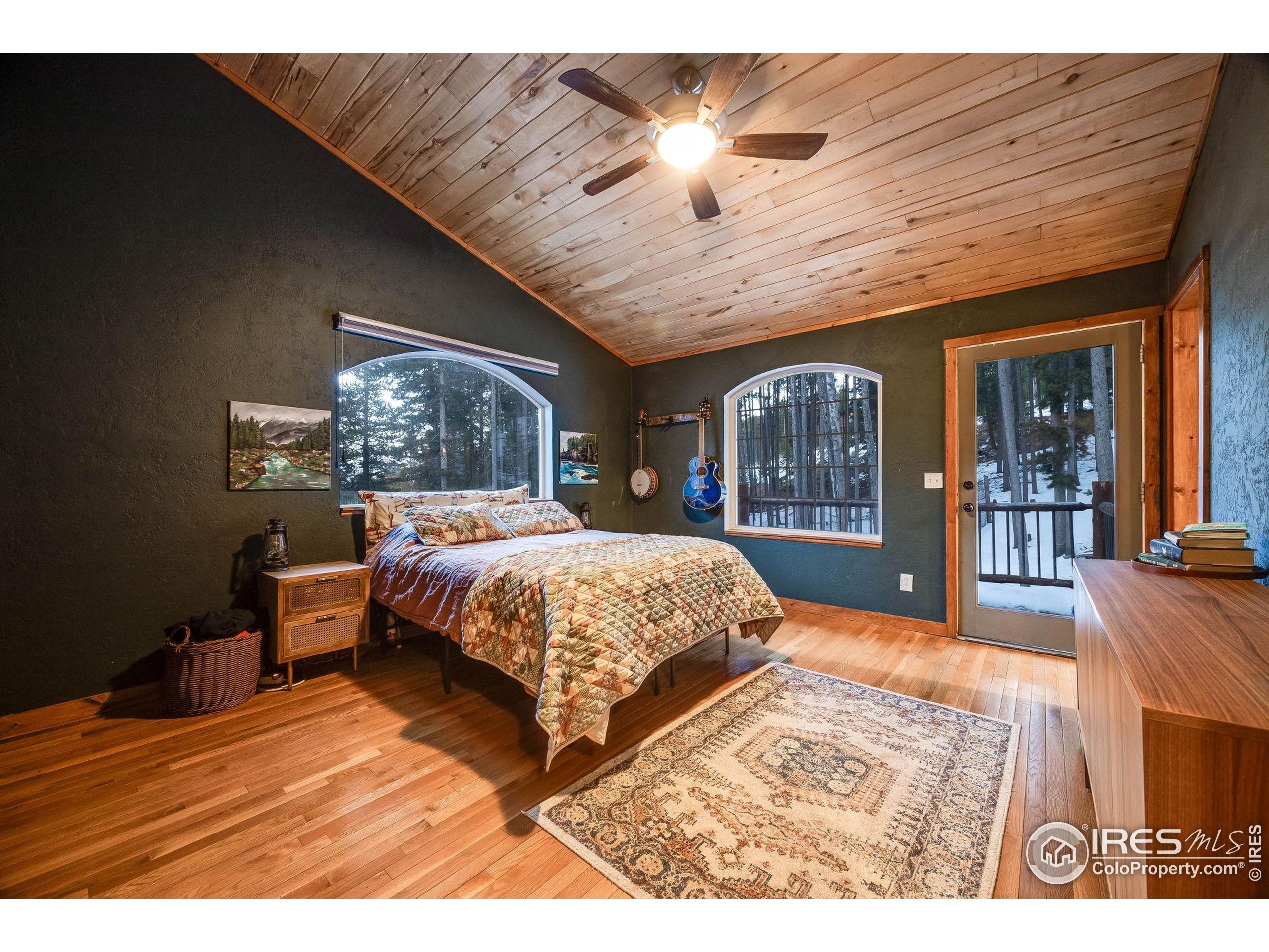 46 Apache Road Evergreen, CO 80439 - Photo 23 of 39 a bedroom with a large bed and a large window