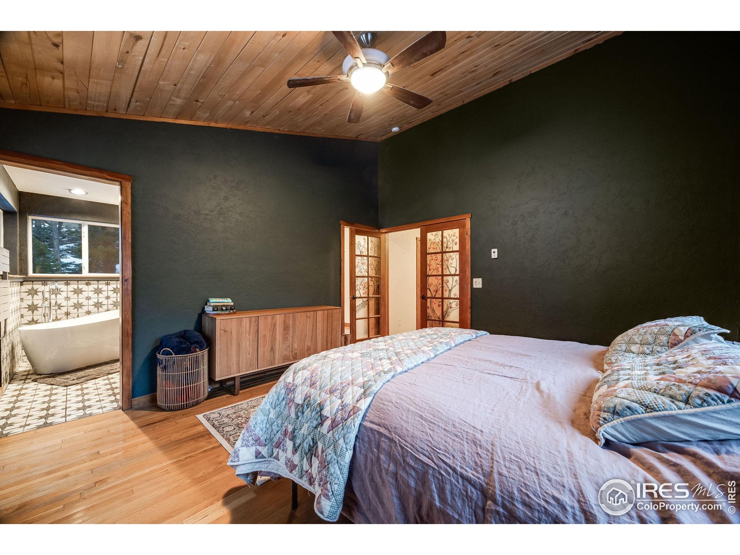 46 Apache Road Evergreen, CO 80439 - Photo 25 of 39 a bedroom with a bed and a dresser with chair