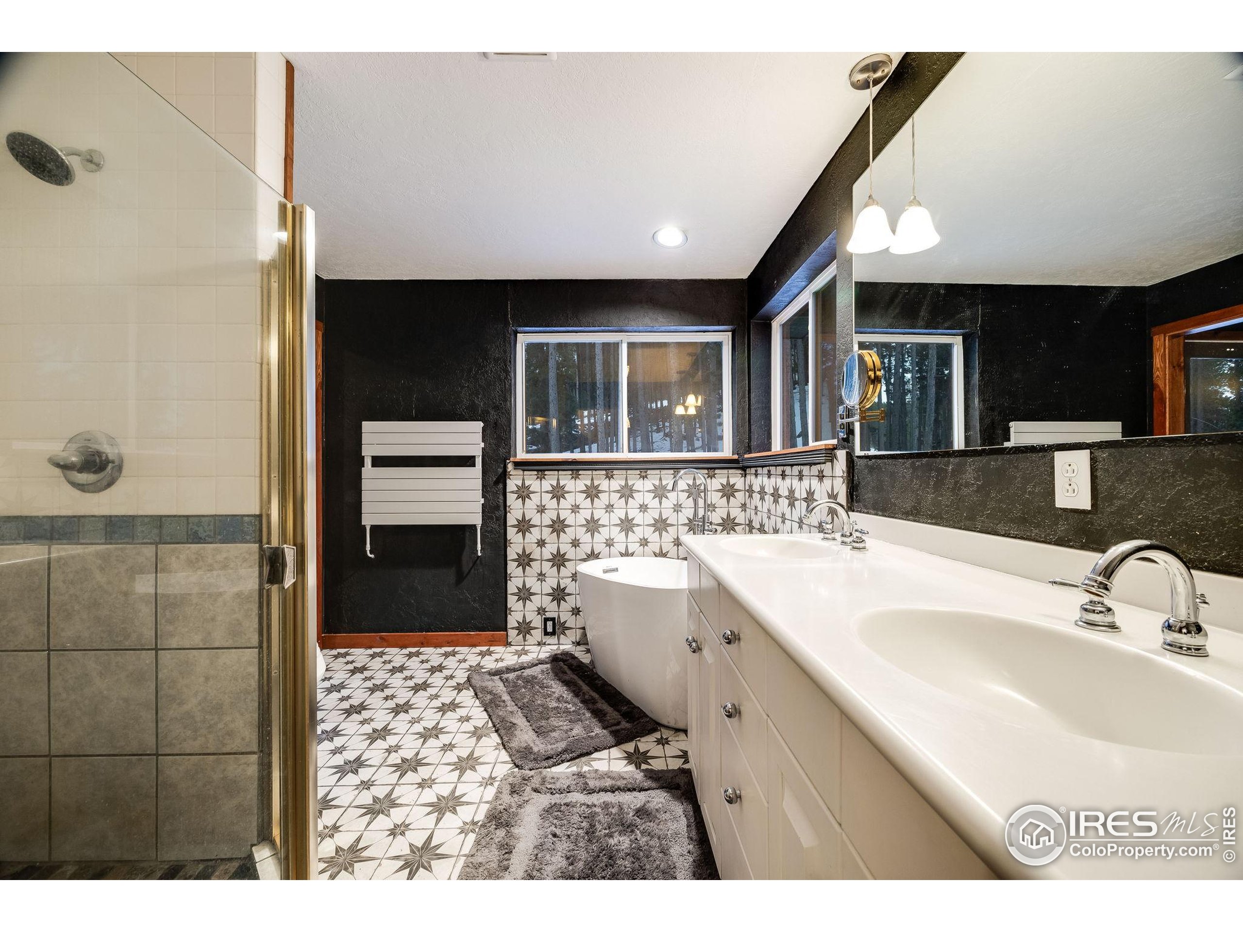 46 Apache Road Evergreen, CO 80439 - Photo 27 of 39 a bathroom with a sink a toilet a mirror and shower