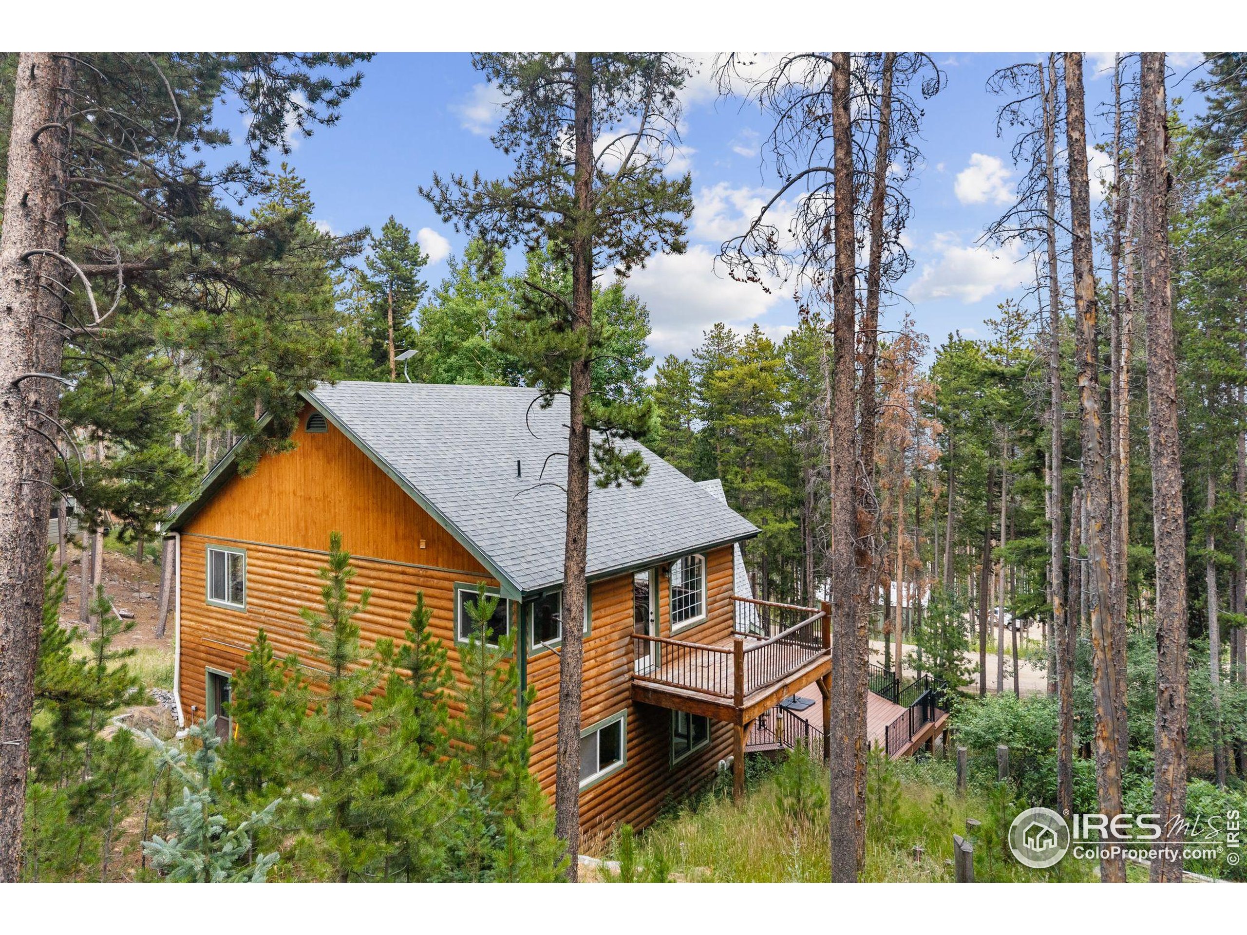46 Apache Road Evergreen, CO 80439 - Photo 35 of 39 a backyard of a house with table and chairs