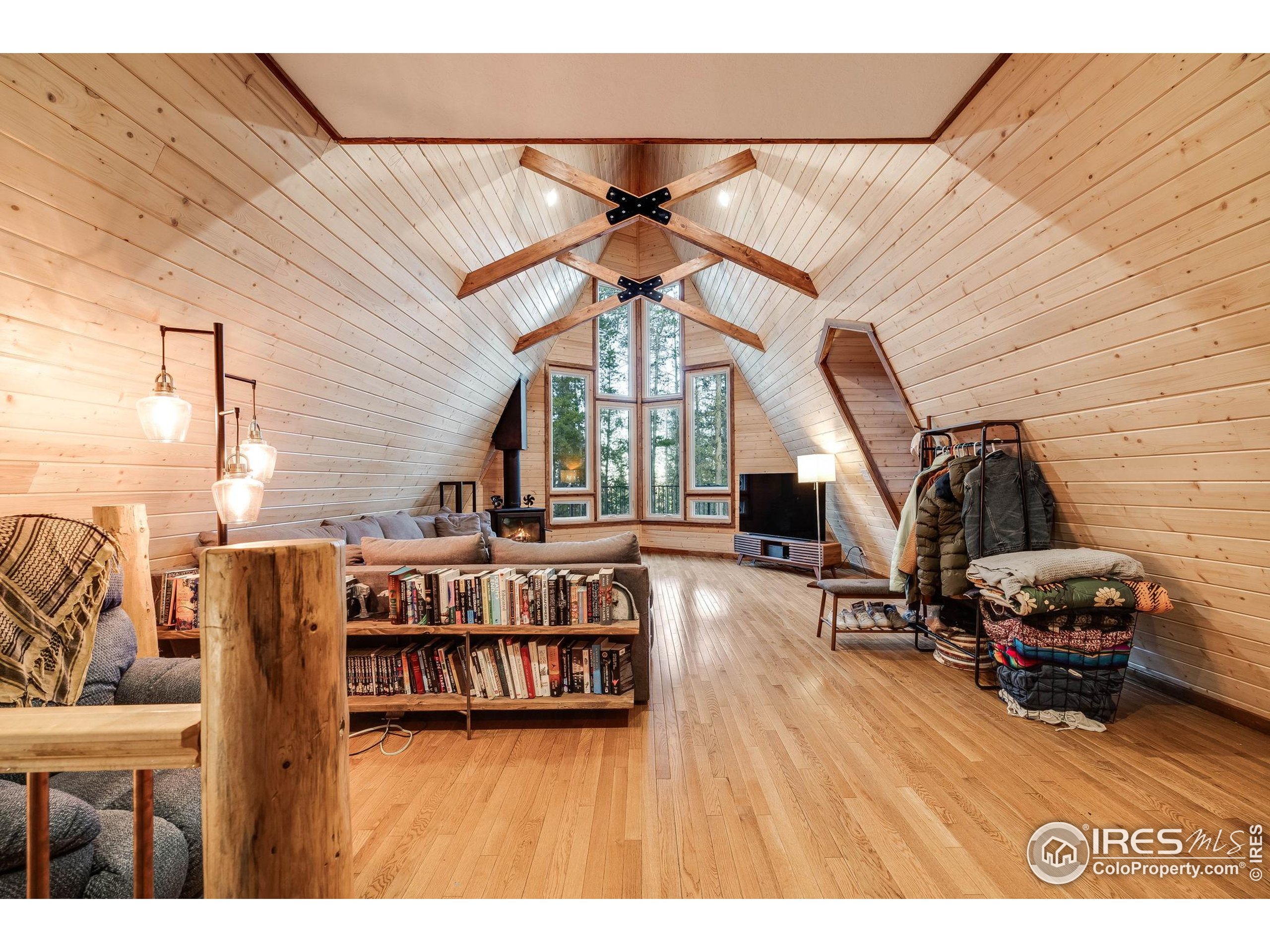 46 Apache Road Evergreen, CO 80439 - Photo 5 of 39 a living room with furniture a flat screen tv and a large window
