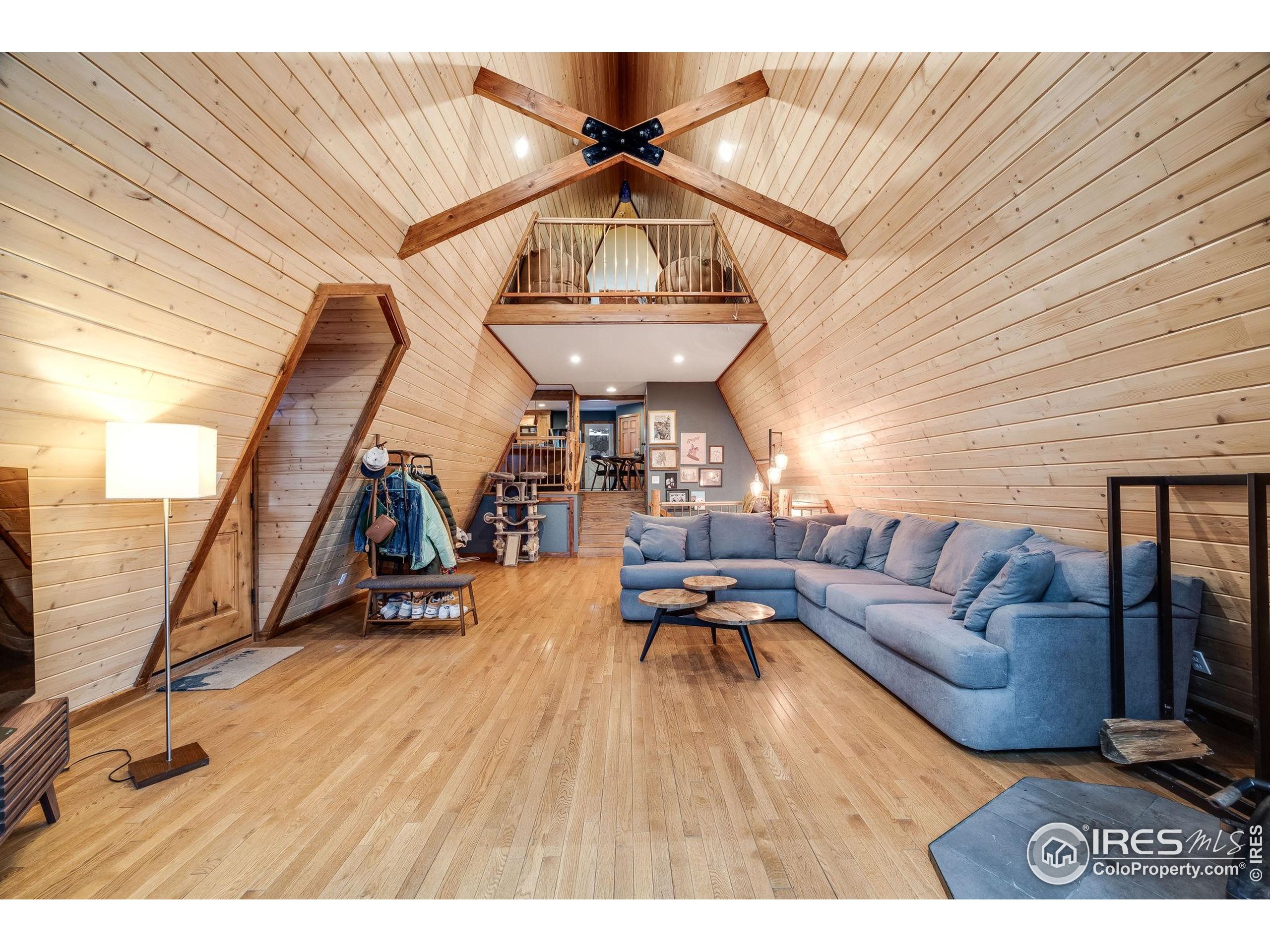 46 Apache Road Evergreen, CO 80439 - Photo 6 of 39 a living room with furniture and a wooden floor