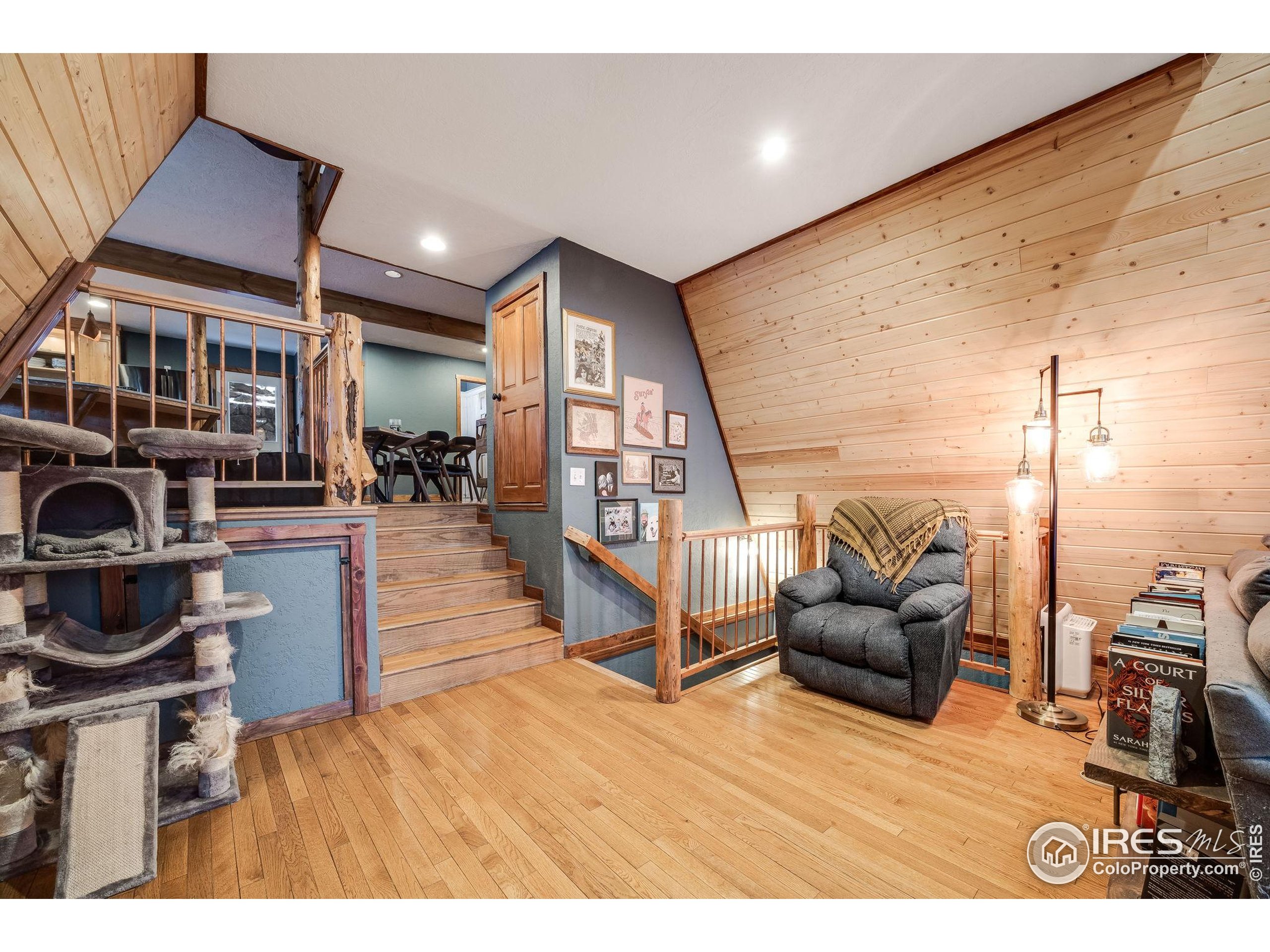 46 Apache Road Evergreen, CO 80439 - Photo 8 of 39 a living room with furniture and a wooden floor