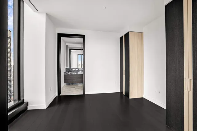 a kitchen with kitchen island granite countertop a sink appliances cabinets and a counter top space