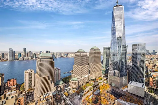 a living room with furniture and large windows