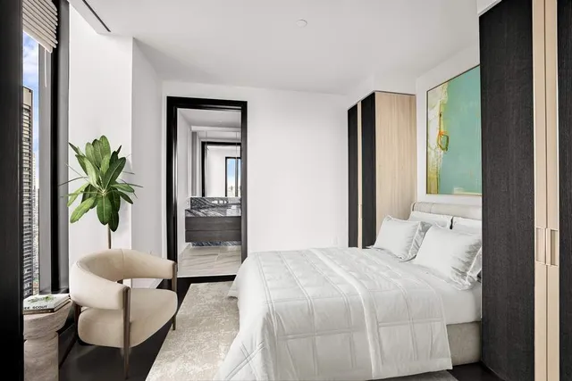 a living room with furniture and floor to ceiling windows