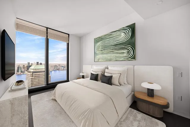 a bedroom with a bed and a potted plant