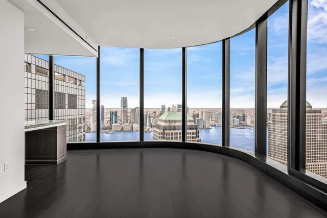 a view of an empty room with windows and city view