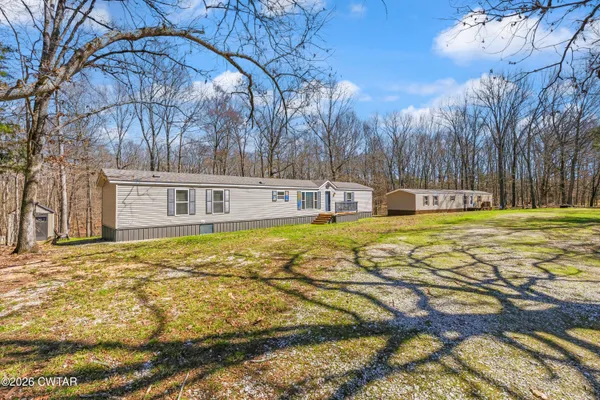 a swimming pool with trees in the background