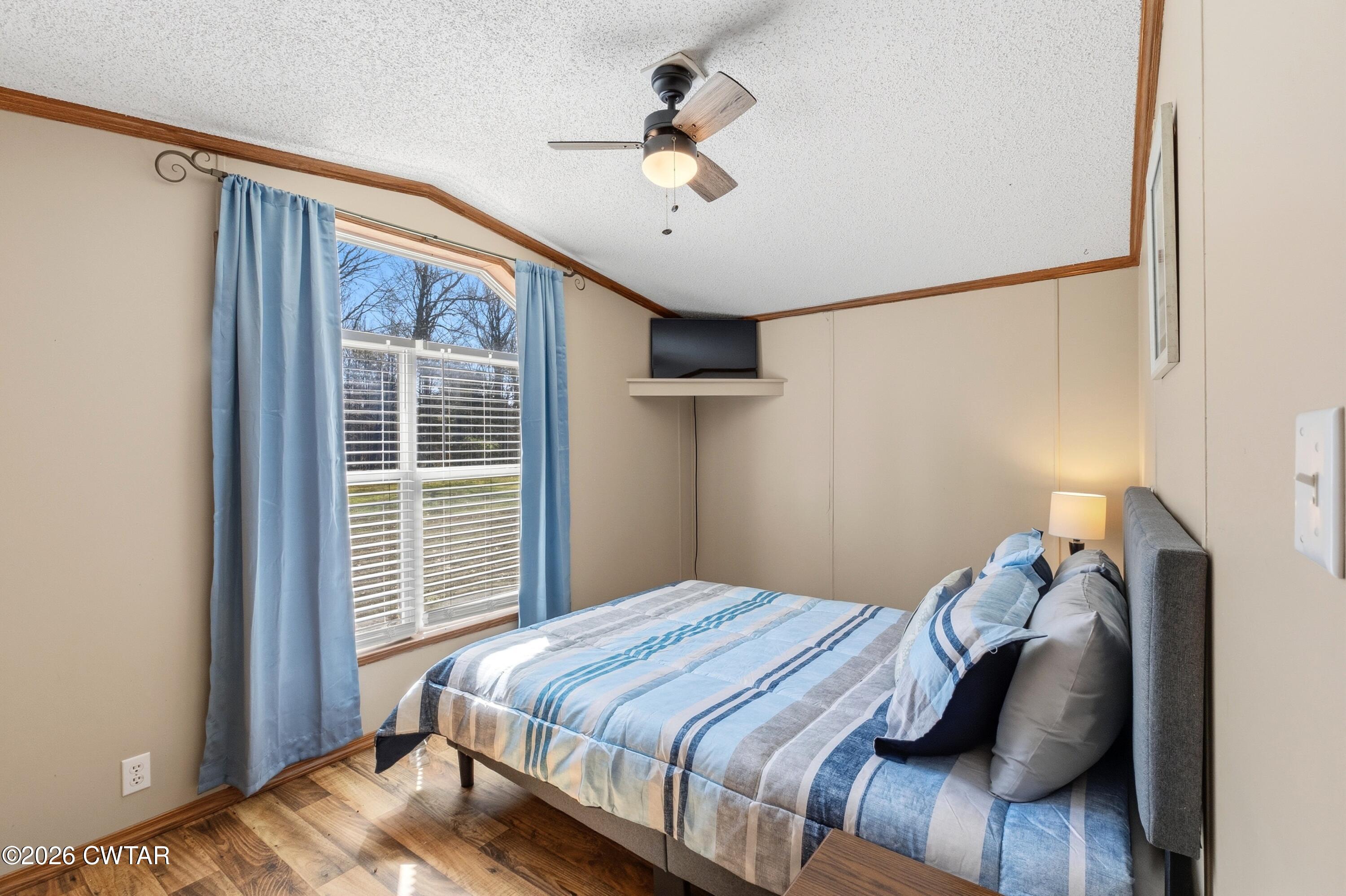 1444-1448 New Hope Road Big Sandy, TN 38221 - Photo 13 of 39 a bedroom with a bed and a window