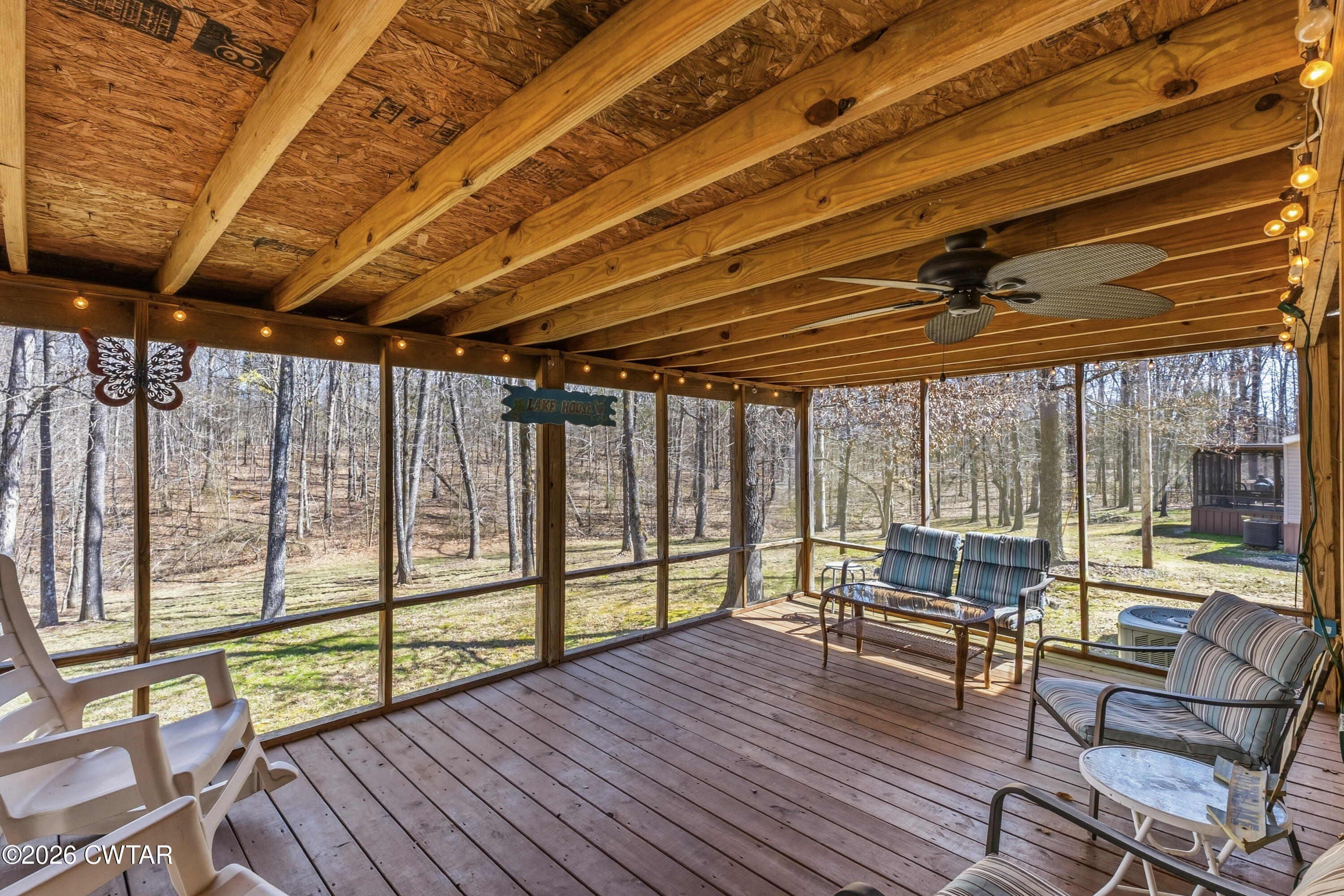 1444-1448 New Hope Road Big Sandy, TN 38221 - Photo 16 of 39 a view of a patio with wooden floor and iron stairs