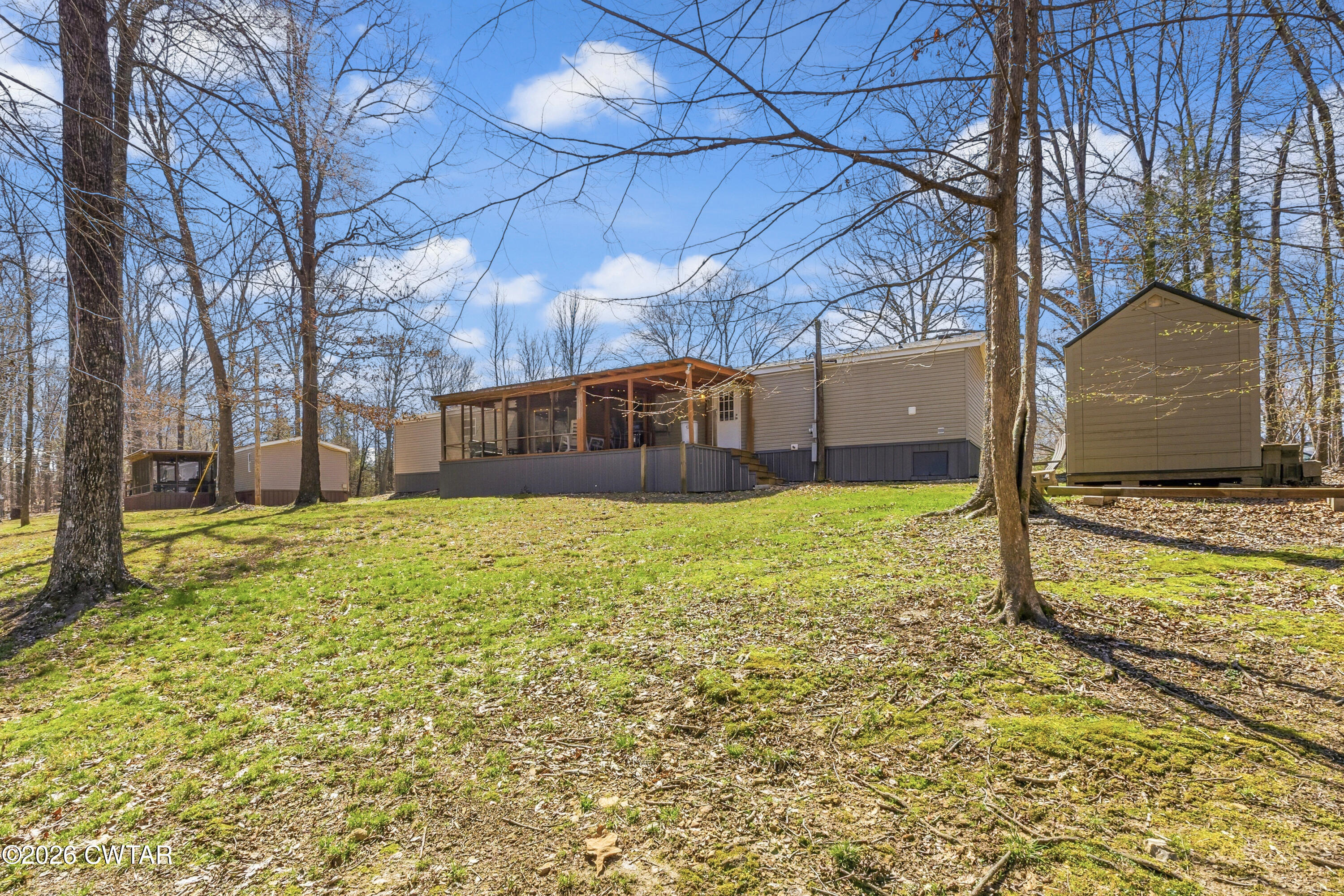 1444-1448 New Hope Road Big Sandy, TN 38221 - Photo 17 of 39 a view of a house with a yard