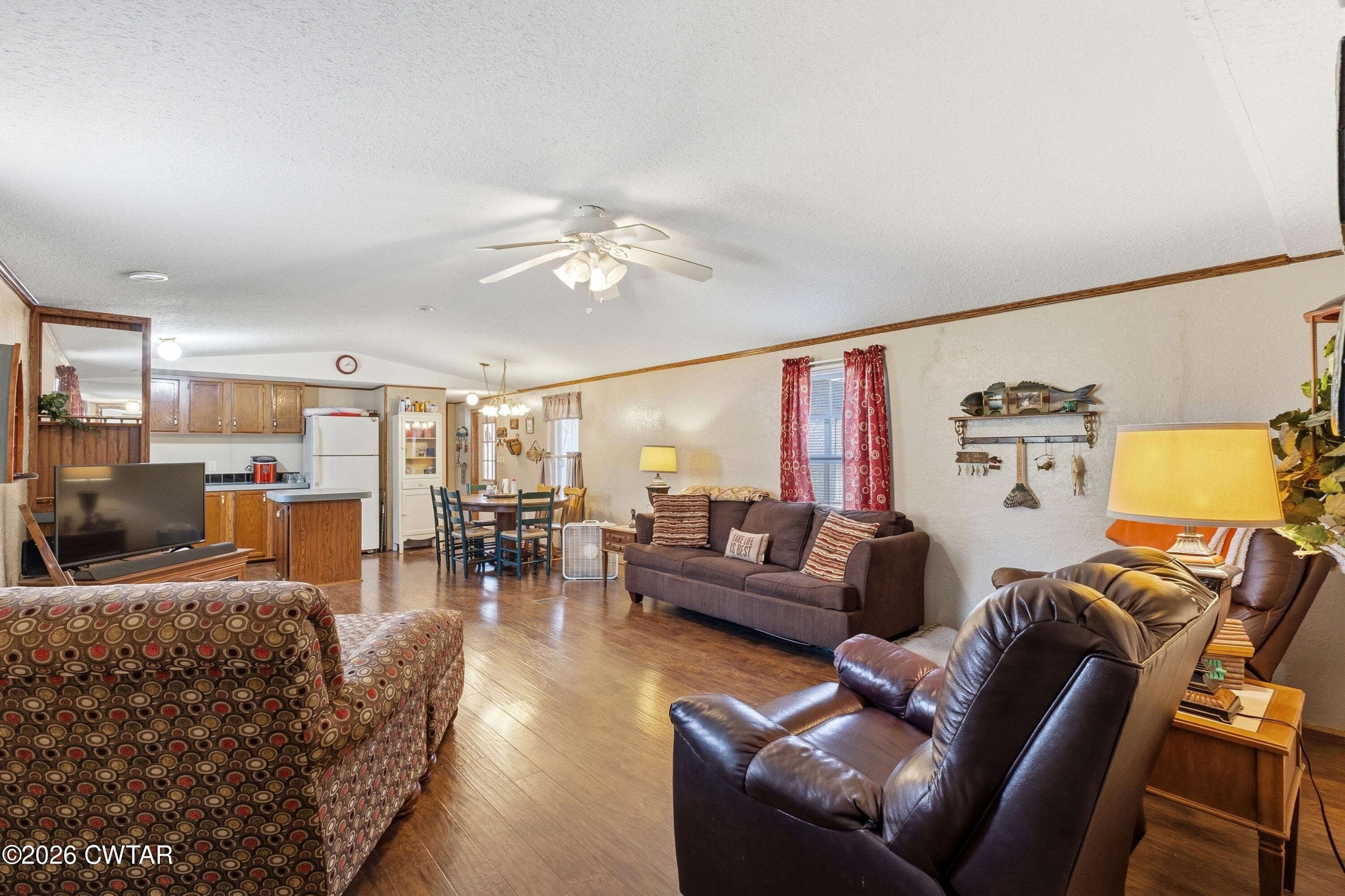 1444-1448 New Hope Road Big Sandy, TN 38221 - Photo 21 of 39 a living room with furniture kitchen view and a chandelier