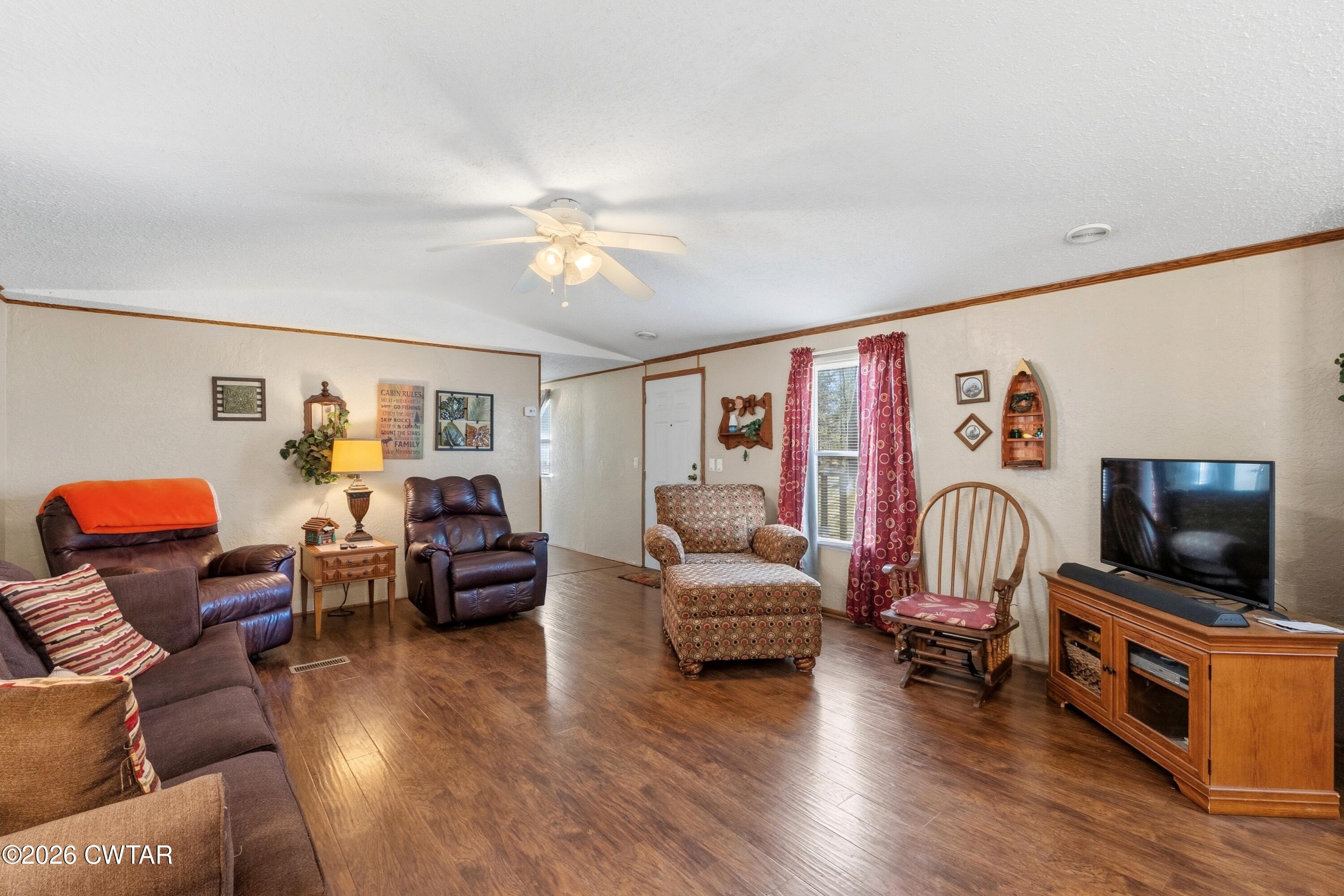 1444-1448 New Hope Road Big Sandy, TN 38221 - Photo 22 of 39 a living room with furniture and wooden floor