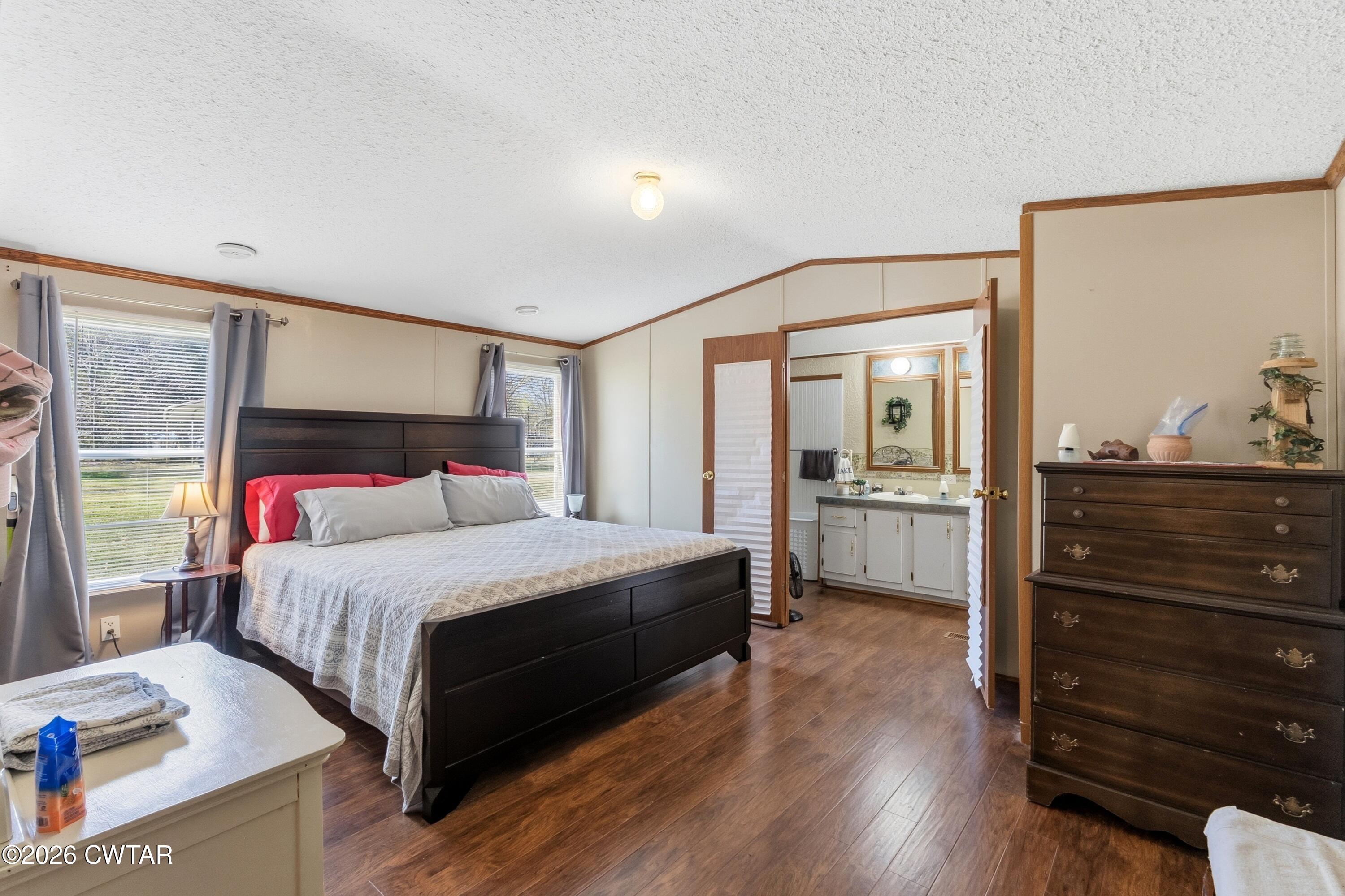 1444-1448 New Hope Road Big Sandy, TN 38221 - Photo 23 of 39 a bedroom with a bed and a dresser