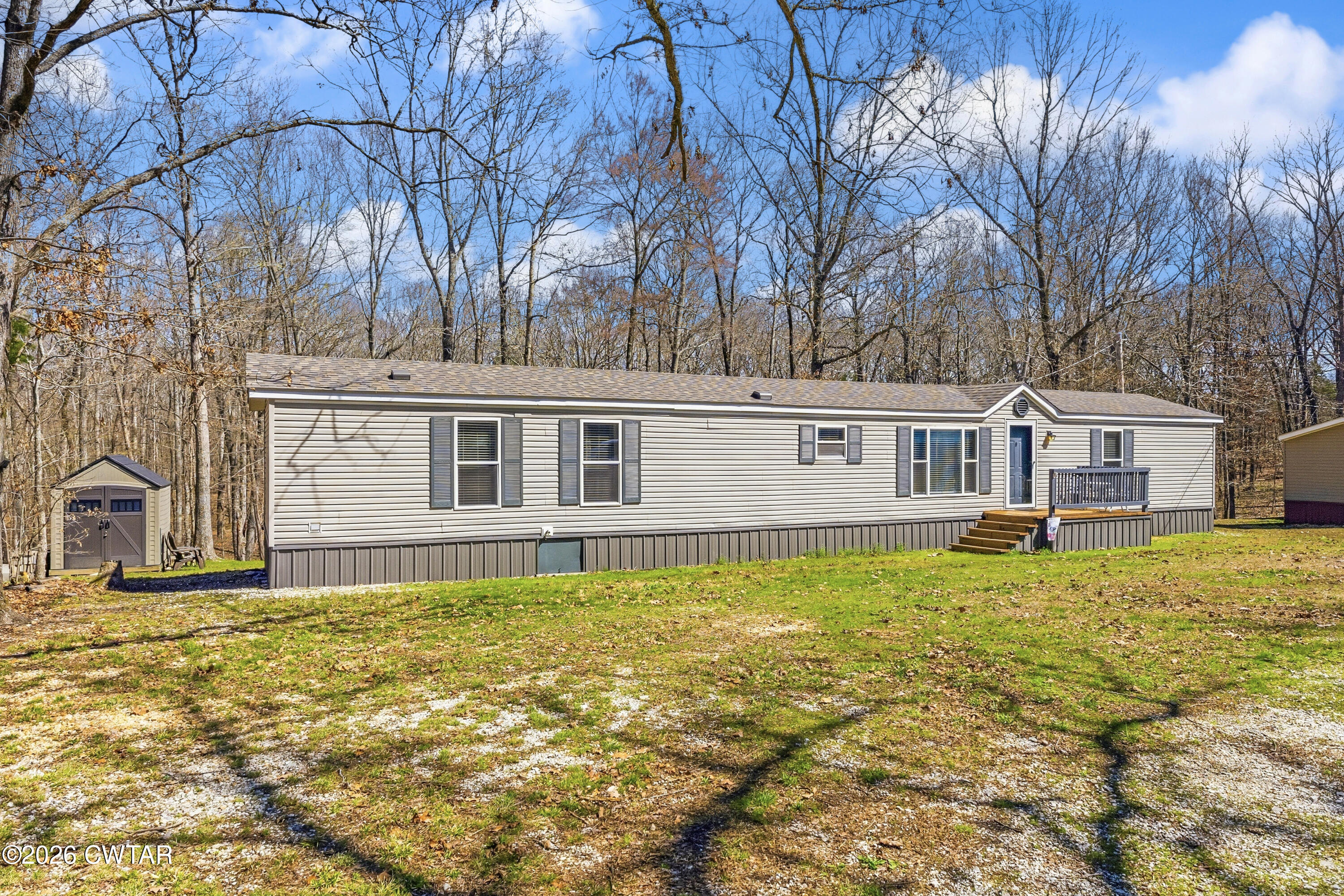 1444-1448 New Hope Road Big Sandy, TN 38221 - Photo 3 of 39 a front view of a house with swimming pool
