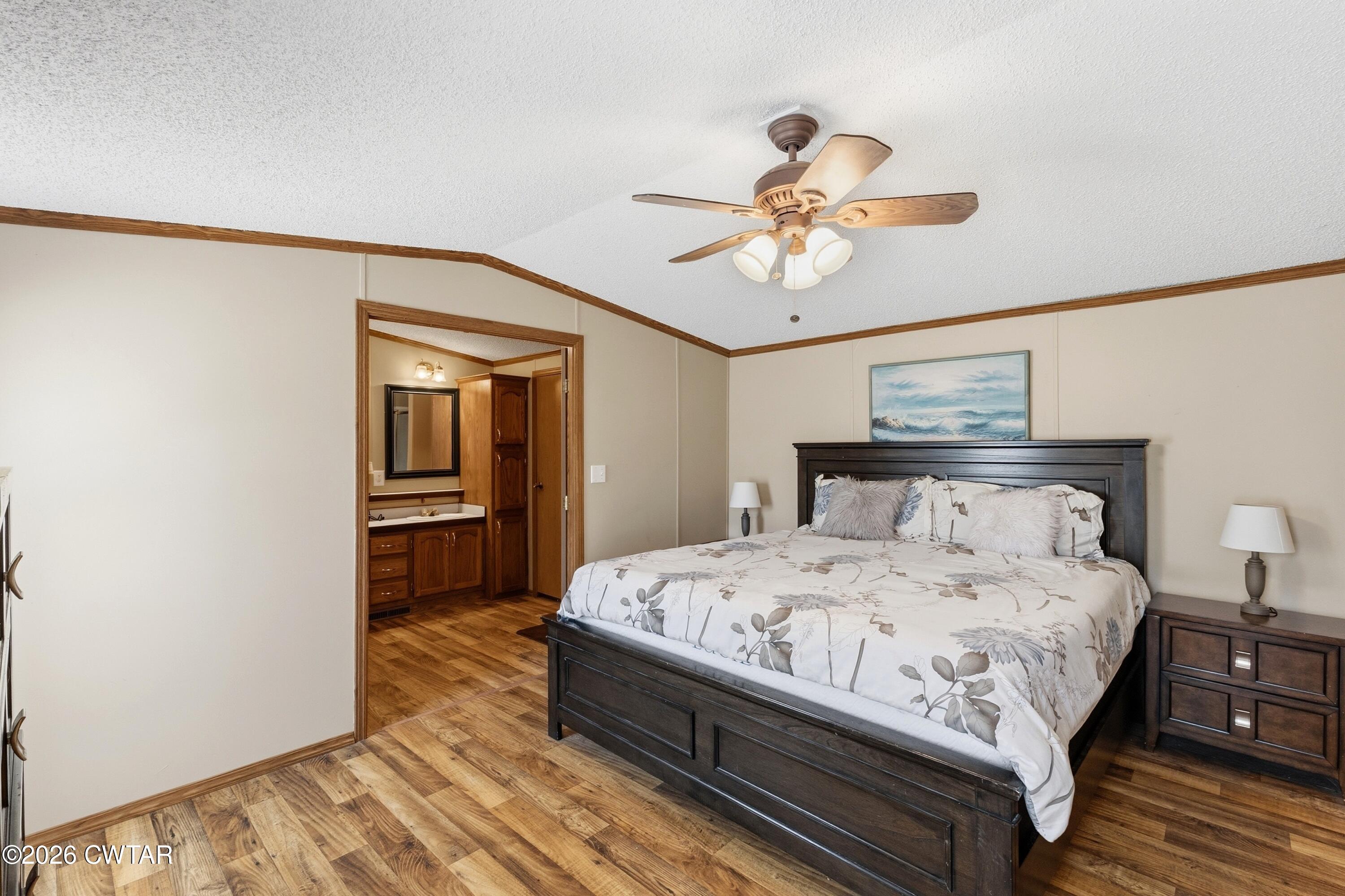 1444-1448 New Hope Road Big Sandy, TN 38221 - Photo 9 of 39 a bedroom with a bed and a chandelier