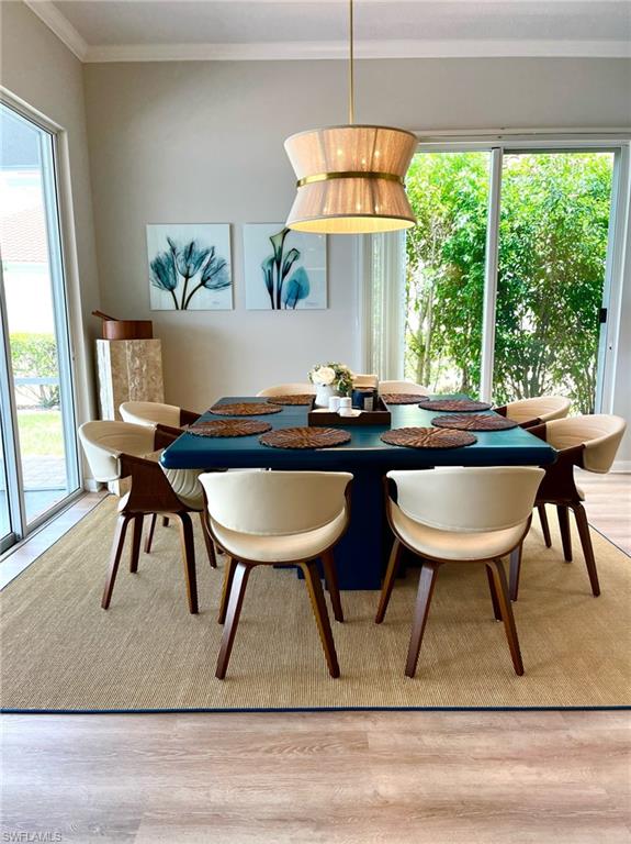 5477 Freeport Lane Naples, FL 34119 - Photo 8 of 36 a view of a dining room with furniture window and outside view