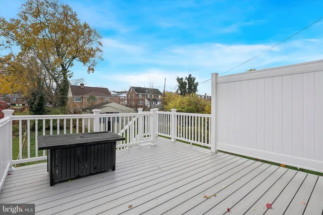 a view of balcony with wooden floor and fence