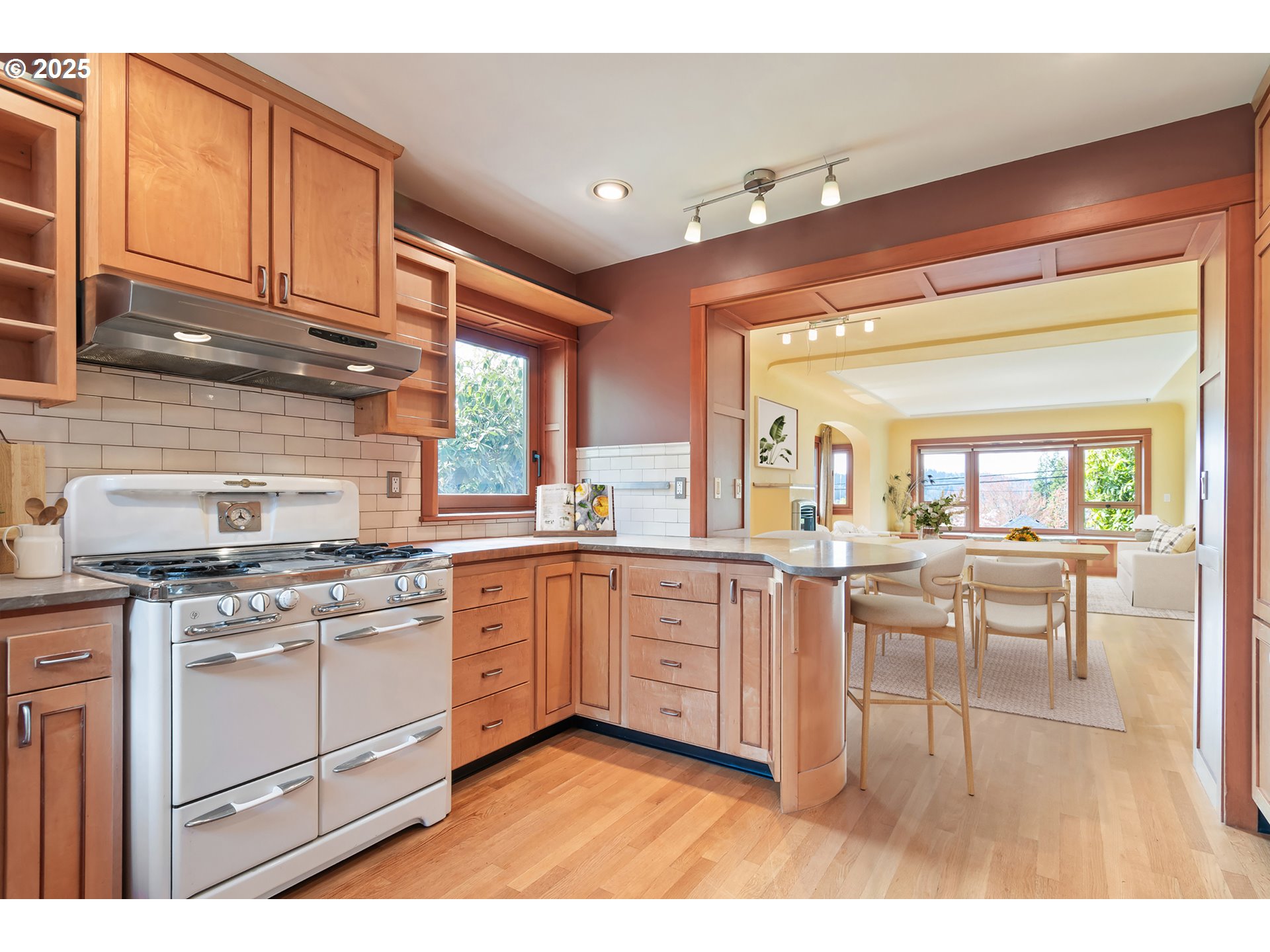 2775 Elinor Street Eugene, OR 97403 - Photo 15 of 48 a kitchen with stainless steel appliances granite countertop a stove a sink dishwasher and white cabinets with wooden floor