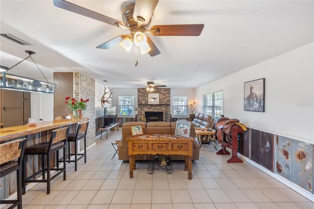 a kitchen with stainless steel appliances kitchen island granite countertop a refrigerator a stove and a sink with cabinets