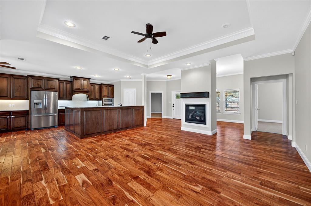 357 Pear Tree Lane Collinsville, TX 76233 - Photo 36 of 37 a view of a kitchen with a stove cabinets and wooden floor