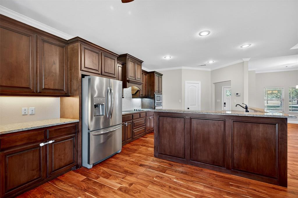 357 Pear Tree Lane Collinsville, TX 76233 - Photo 17 of 37 a kitchen with stainless steel appliances granite countertop a refrigerator and a sink