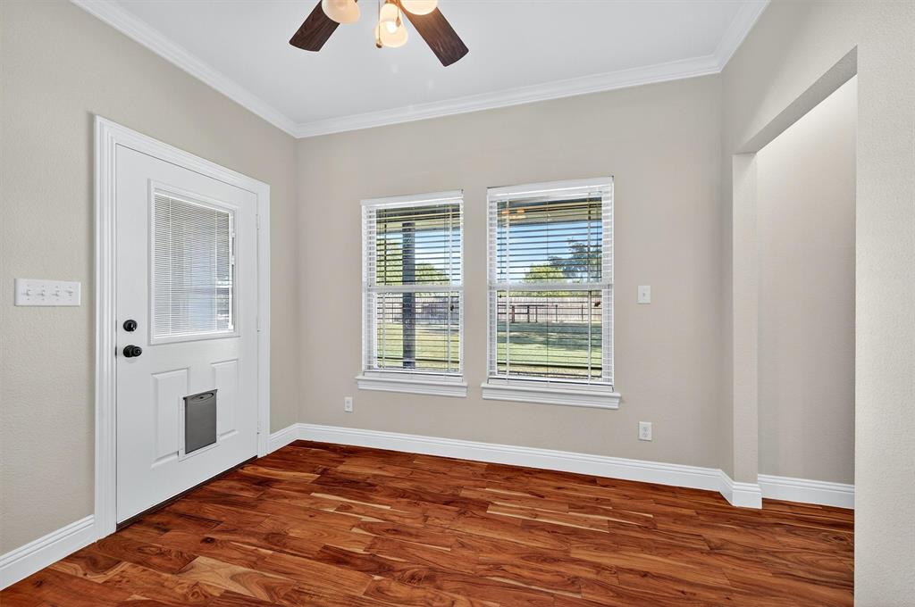 357 Pear Tree Lane Collinsville, TX 76233 - Photo 18 of 37 an empty room with window and wooden floor