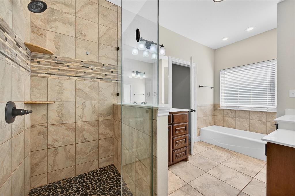 357 Pear Tree Lane Collinsville, TX 76233 - Photo 21 of 37 a bathroom with a bathtub and a shower