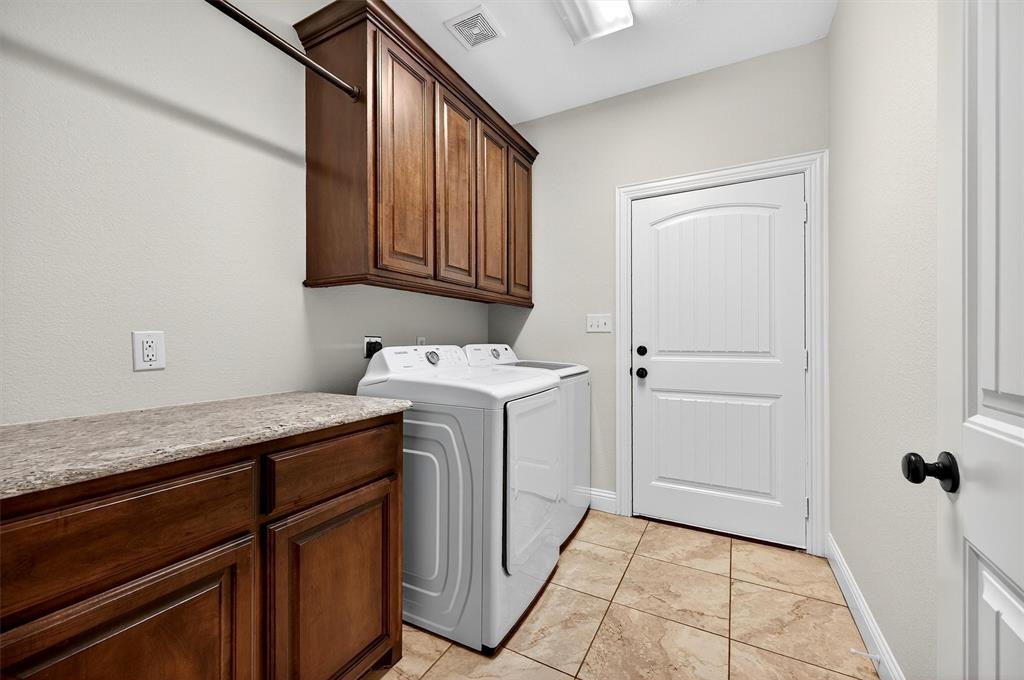 357 Pear Tree Lane Collinsville, TX 76233 - Photo 23 of 37 a utility room with granite countertop cabinets washer and dryer
