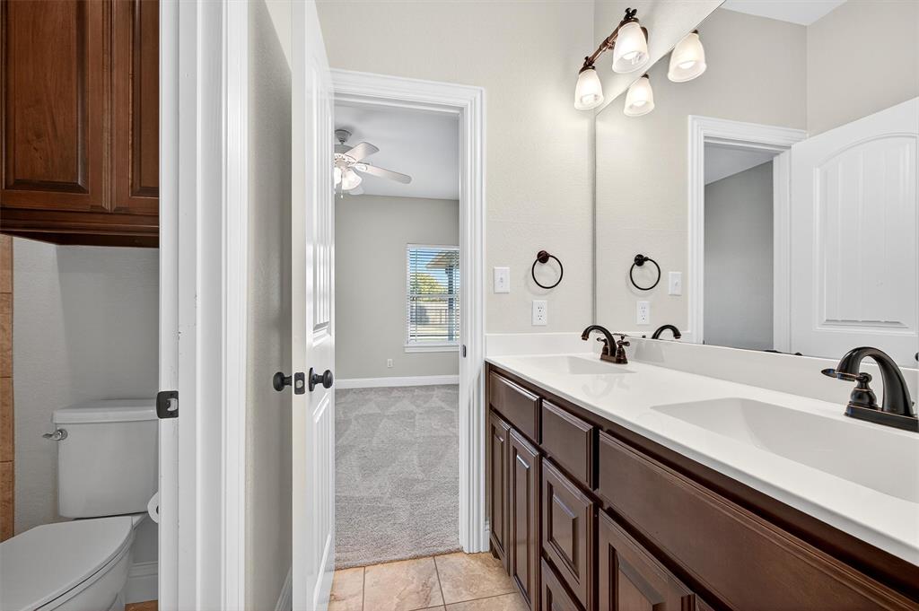 357 Pear Tree Lane Collinsville, TX 76233 - Photo 27 of 37 a bathroom with a sink a toilet and shower