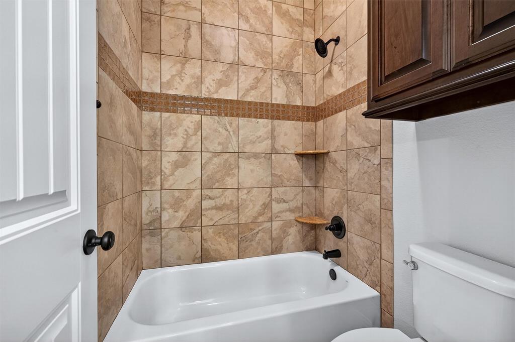 357 Pear Tree Lane Collinsville, TX 76233 - Photo 28 of 37 a bathroom with a bathtub