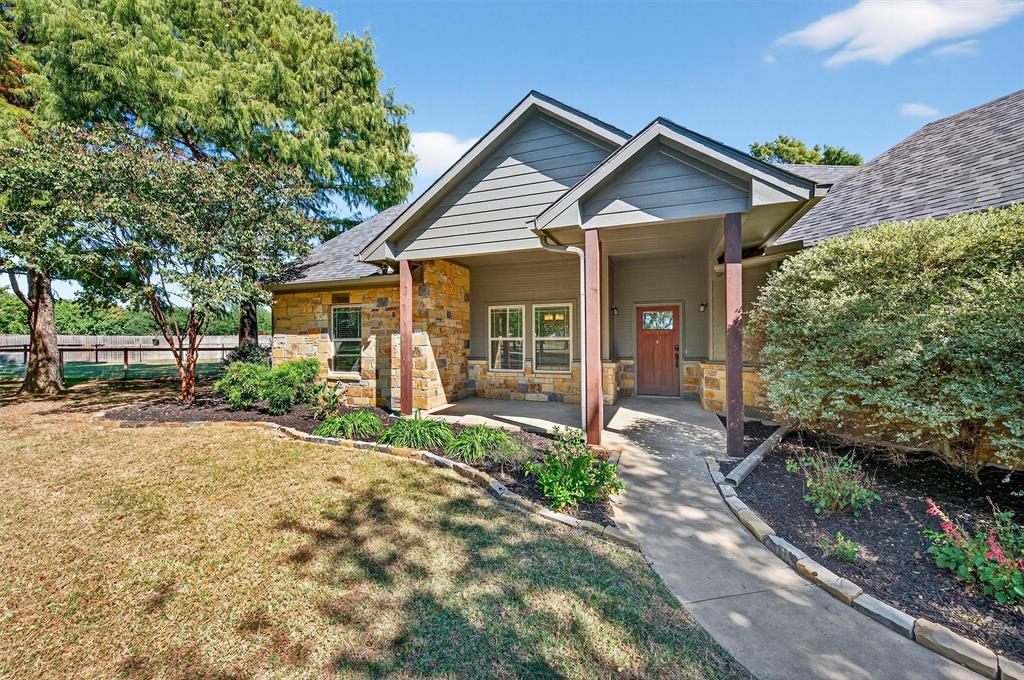 357 Pear Tree Lane Collinsville, TX 76233 - Photo 9 of 37 a front view of a house with a garden