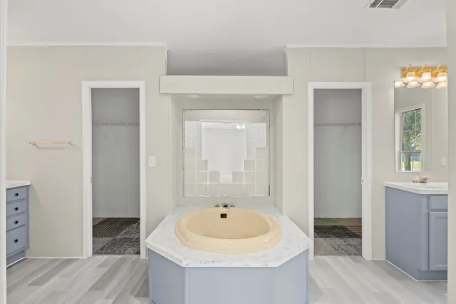 a bathroom with bathtub and window