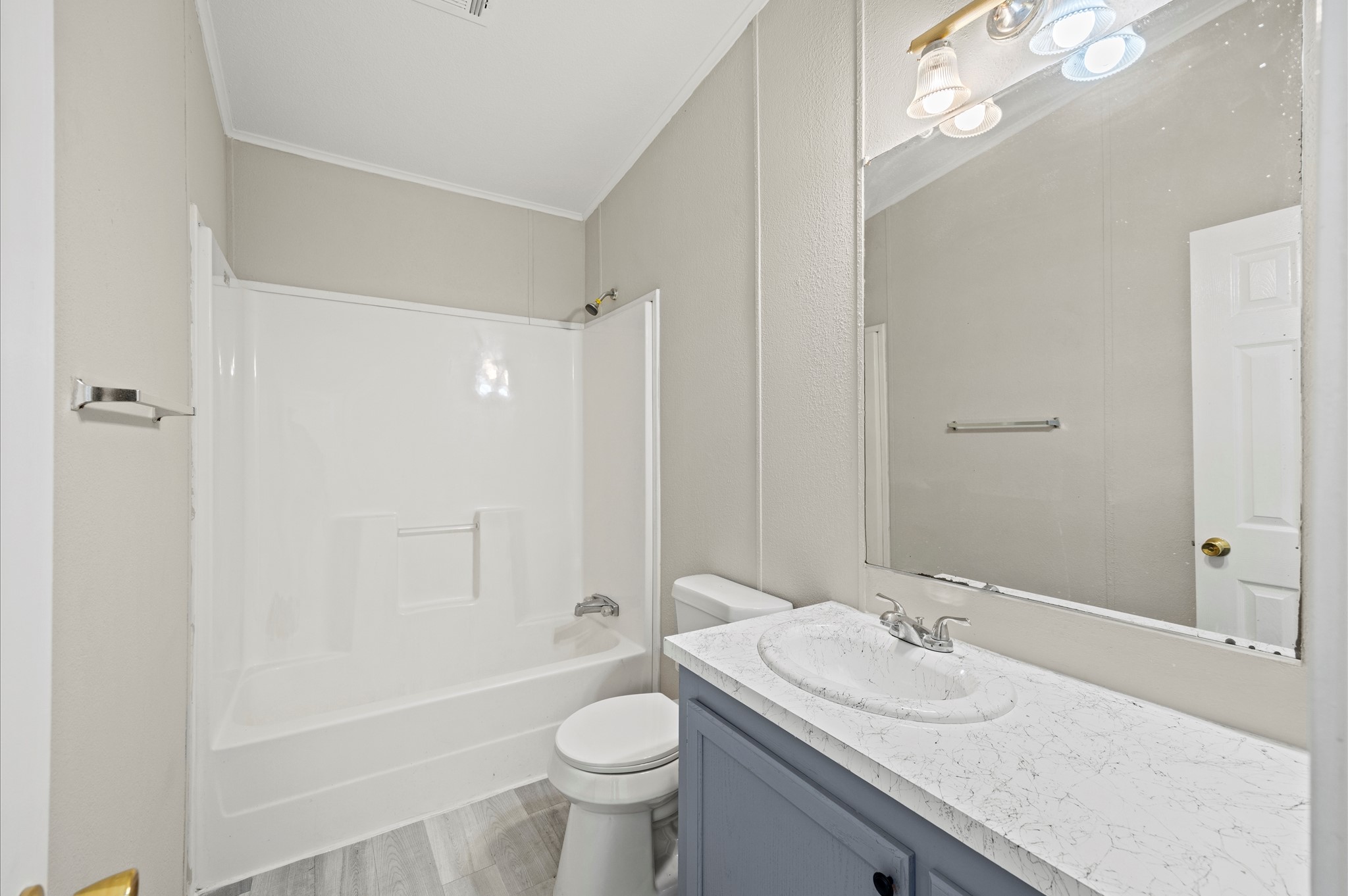 2701 Farm To Market 1127 Shepherd, TX 77371 - Photo 20 of 30 a bathroom with a granite countertop sink toilet mirror and bathtub