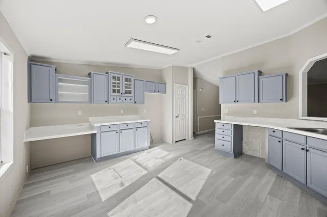 a large white kitchen with cabinets