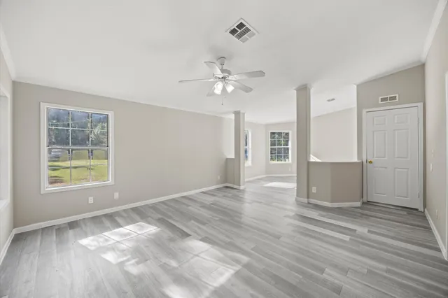 wooden floor in an empty room with a window