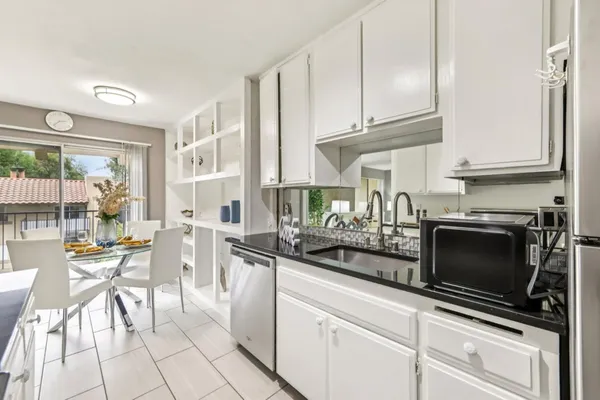 a kitchen with stainless steel appliances kitchen island granite countertop a stove a sink and a microwave
