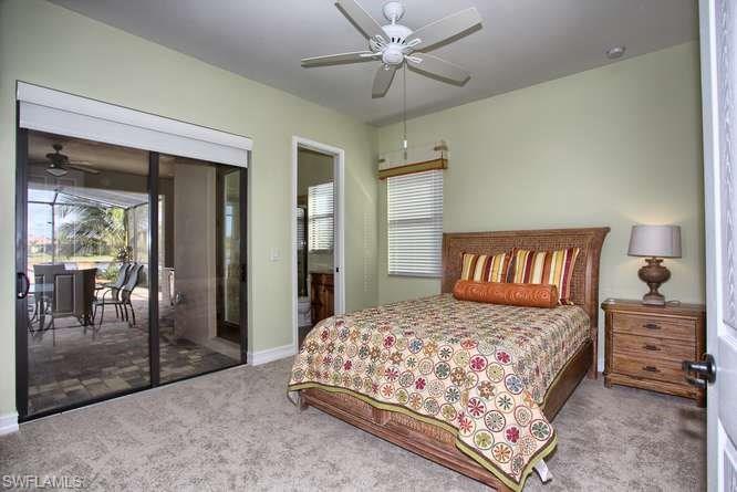 9633 Firenze Circle Naples, FL 34113 - Photo 13 of 25 a bedroom with a bed and a table