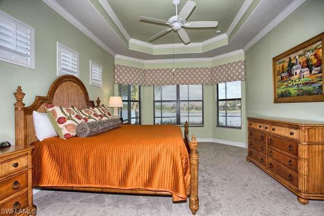 9633 Firenze Circle Naples, FL 34113 - Photo 16 of 25 a bedroom with a bed a dresser next to a window