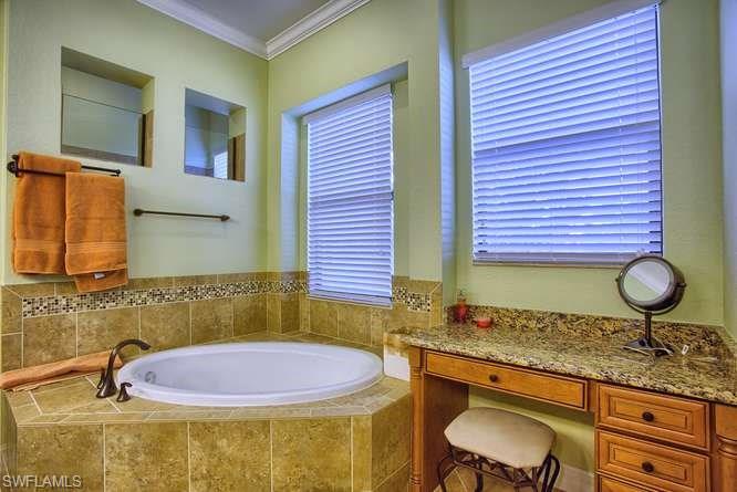 9633 Firenze Circle Naples, FL 34113 - Photo 18 of 25 a bathroom with a granite countertop sink and a mirror