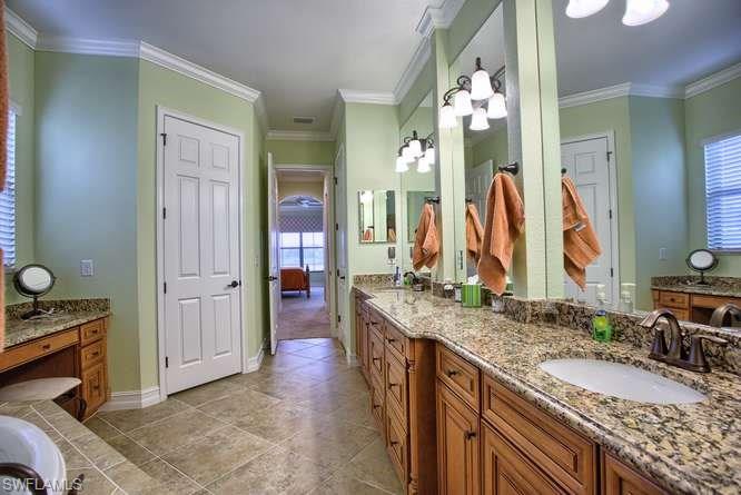 9633 Firenze Circle Naples, FL 34113 - Photo 19 of 25 a bathroom with a granite countertop double vanity sink and a mirror