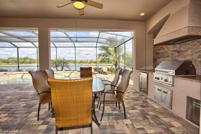9633 Firenze Circle Naples, FL 34113 - Photo 23 of 25 a dining room with furniture a chandelier and wooden floor