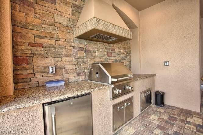 9633 Firenze Circle Naples, FL 34113 - Photo 24 of 25 a kitchen with a sink a stove and cabinets