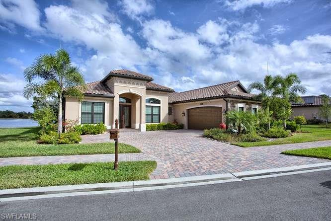 9633 Firenze Circle Naples, FL 34113 - Photo 3 of 25 a front view of a house with a yard and garage