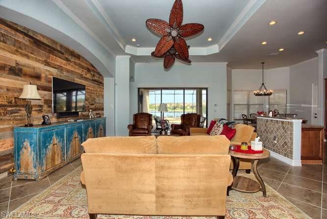9633 Firenze Circle Naples, FL 34113 - Photo 4 of 25 a living room with furniture a window and kitchen view